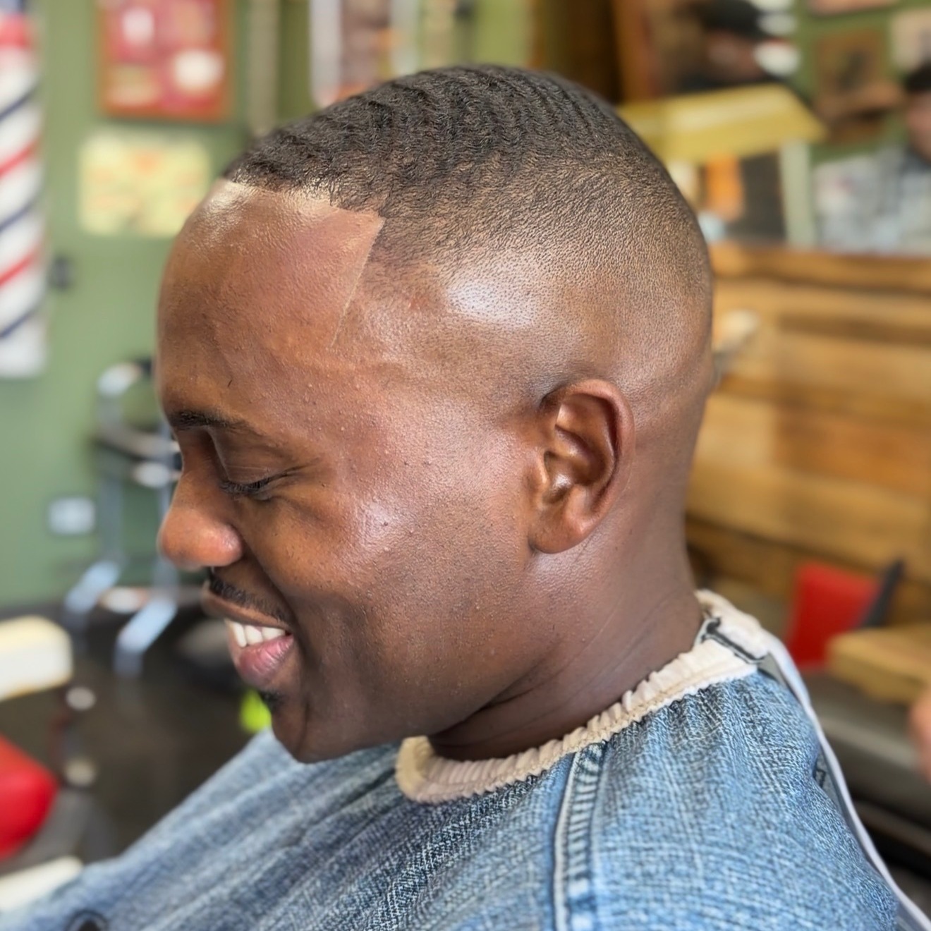 Client smiling with a fresh fade and sharp lineup